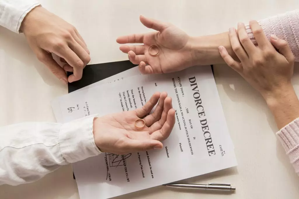 hands with divorce decree close up scaled