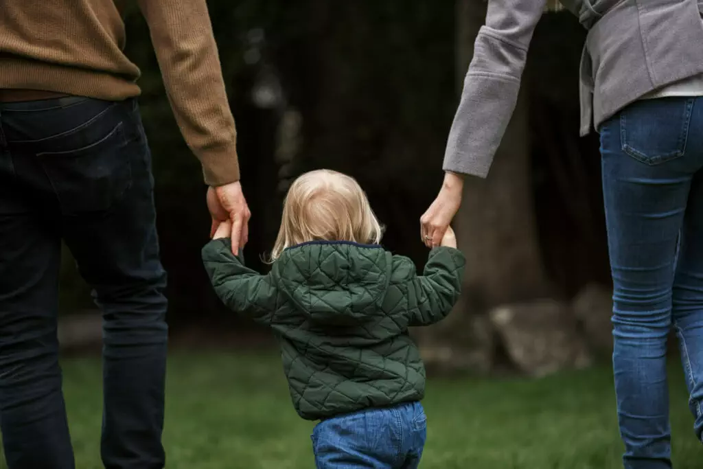 parents walking with kid park 1
